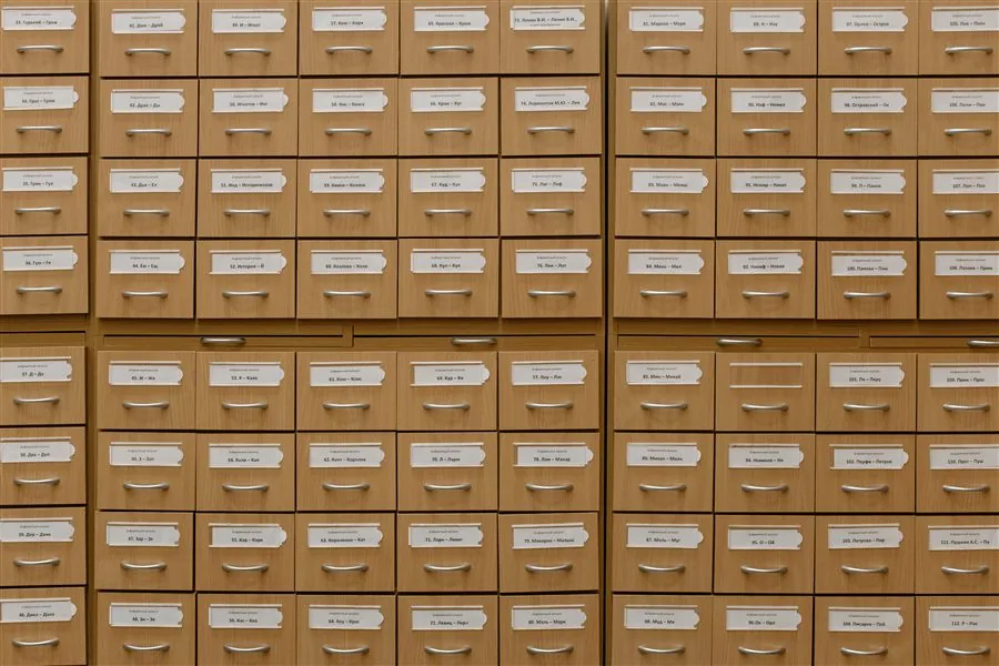 Research consultation with archival card catalog